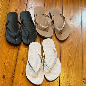 Set of Three Flip Flops in Black, Brown, and White